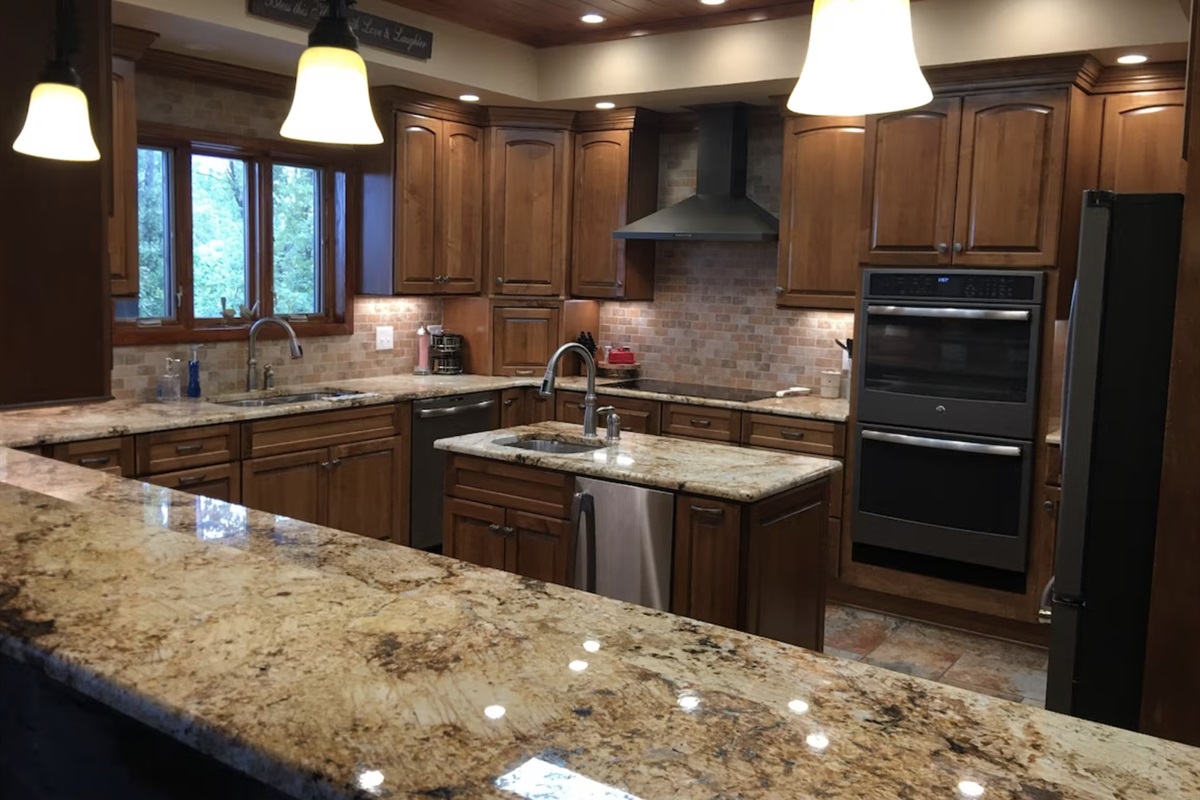 The kitchen has a double oven, an ice machine, a wine cooler, and a large island