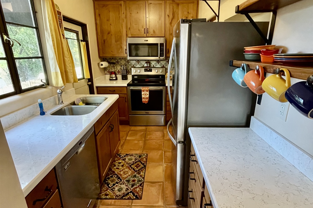 Cooking is a breeze in this fully equipped kitchen, featuring modern appliances and ample counter space.