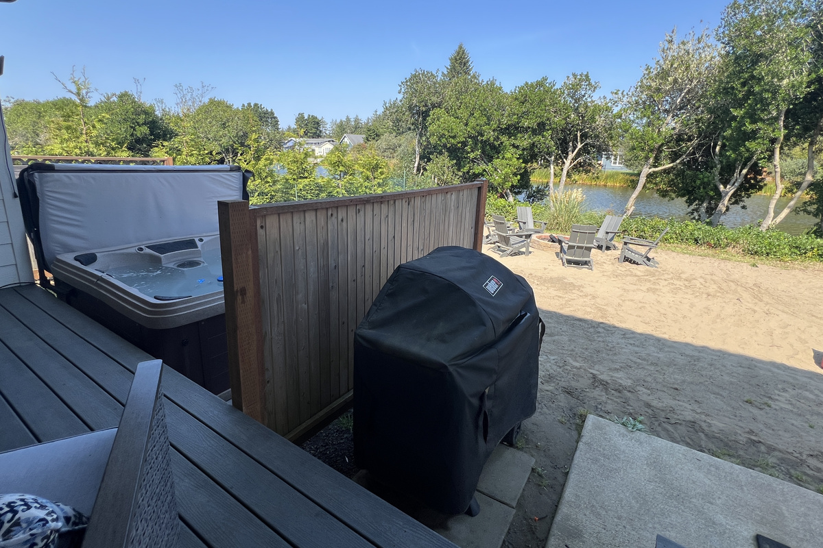 Cozy up under cover on the back deck, rain or shine — your spot to relax between hot tub soaks.