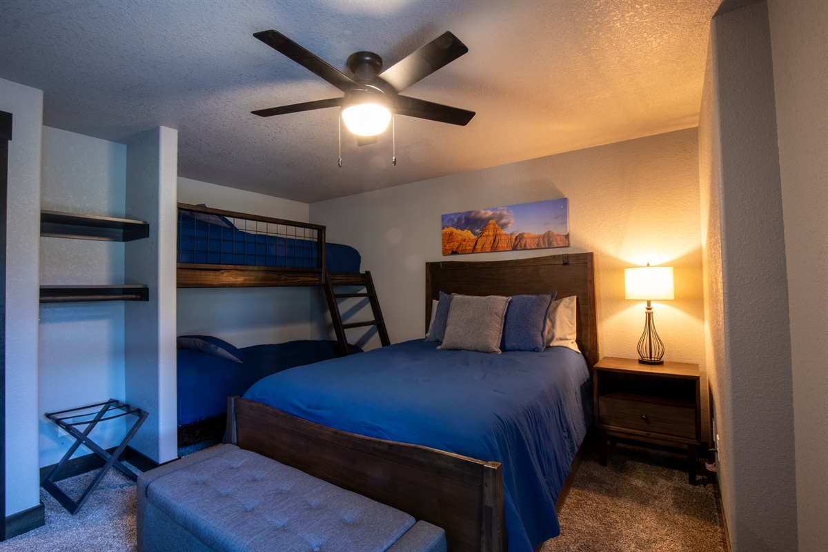 Perfect for families or groups, this lower-level bedroom features a cozy queen bed and 2 sets of twin bunks—plenty of space for kids, teens, or extra guests to rest and recharge.