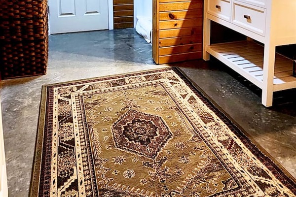 The bathroom at Misty Oak Lodge blends cabin charm with clean, modern touches. Enjoy a bright, spacious layout with a full standing shower, soft towels, and plenty of counter space to refresh after a day outdoors.