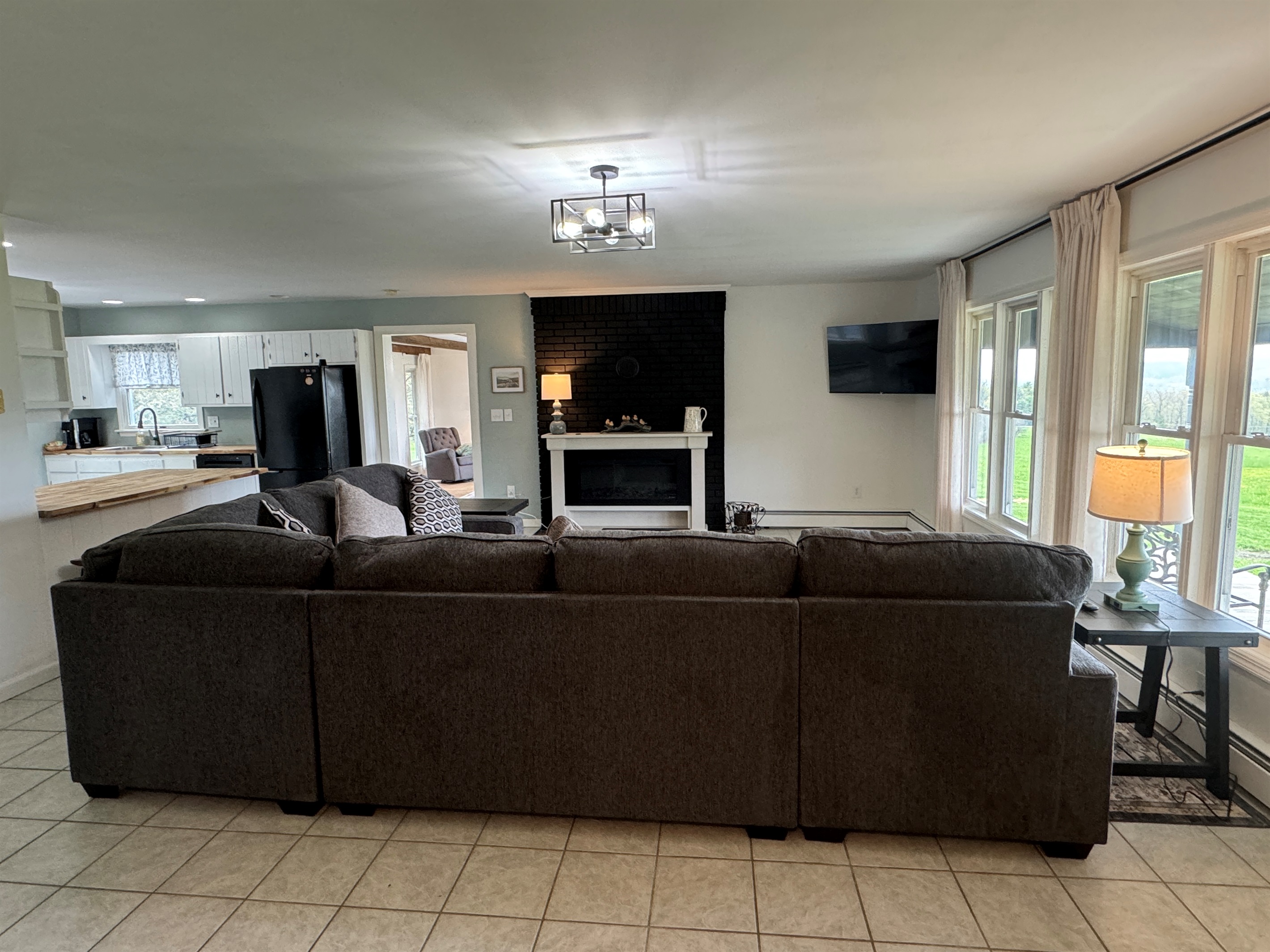 Large living room with sectional couch and SmartTV