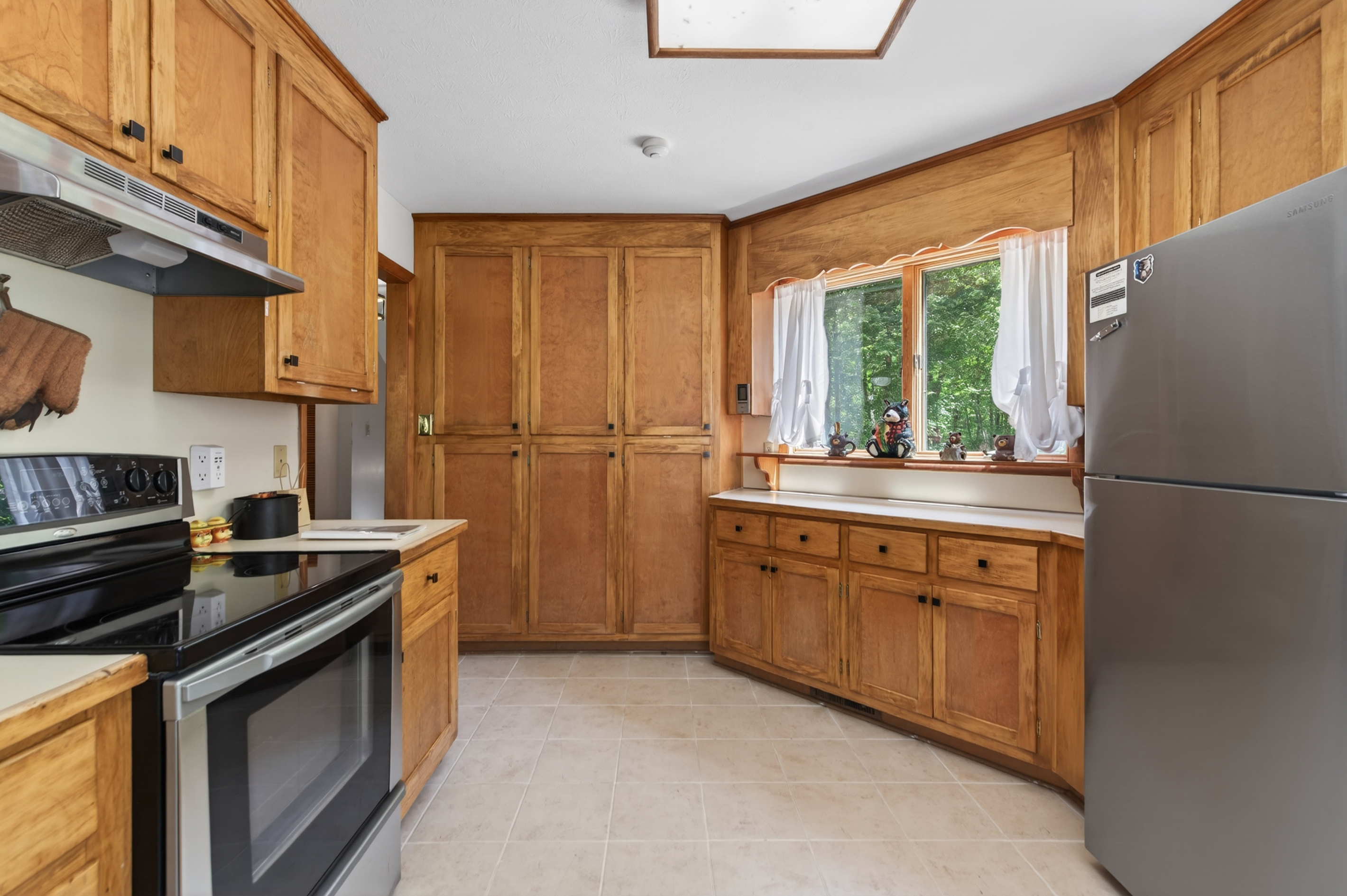 Kitchen: Whip up culinary creations in this spacious, sunlit kitchen with modern appliances!