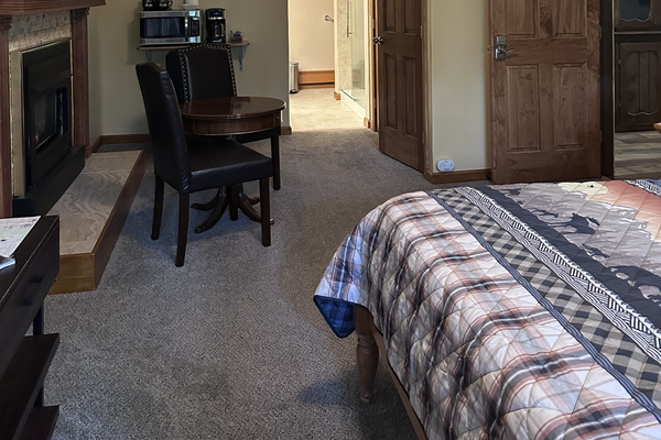 The Majestic Moose Room with a queen bed, fireplace and private sitting area