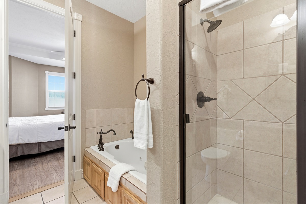 Full bathroom featuring a spa-style soaking tub and spacious walk-in shower.