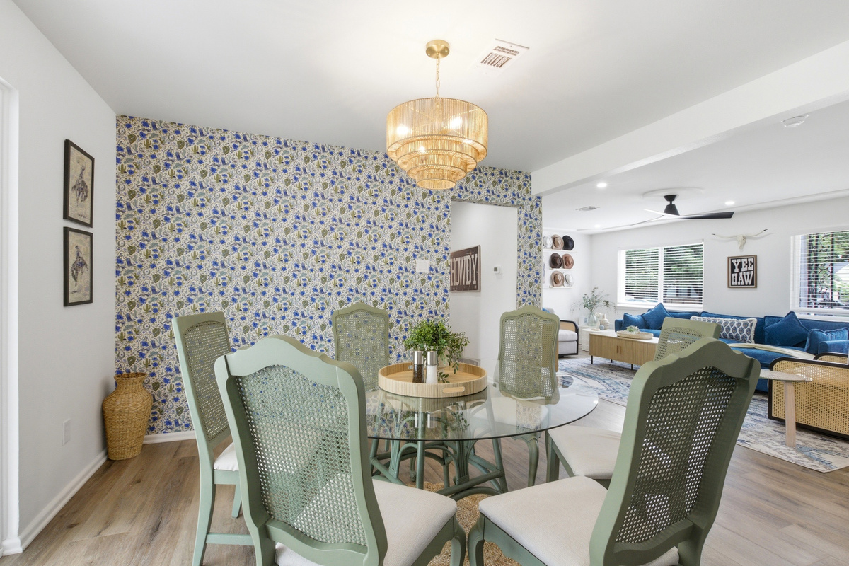 Dining Room with seating for the full group, chandelier lighting, and patterned accent wall. Gather for breakfast, game-day spreads, and post-Six Flags dinners.
