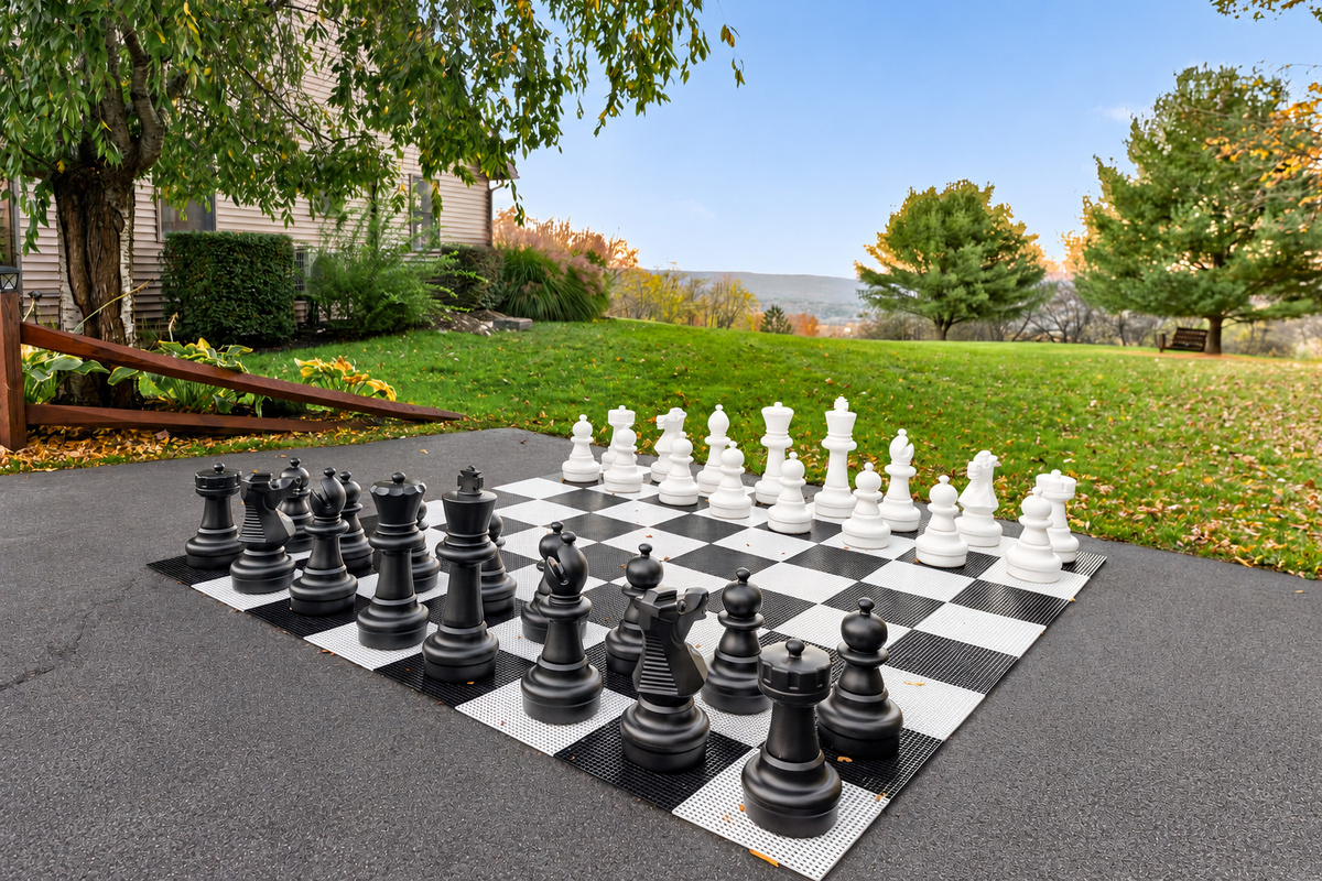Oversized outdoor chessboard on paved court
