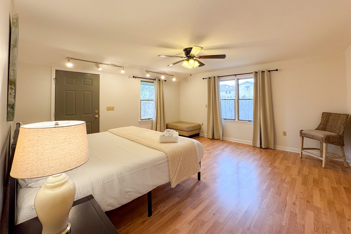 The master bedroom features a king size bed, large space, closet, and ensuite bathroom with accessibility features.