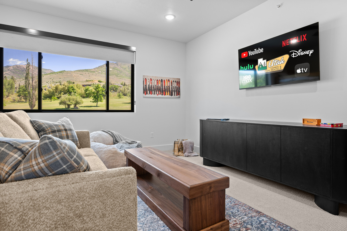 Large upstairs media and bunk room with Smart TV and mountain views.