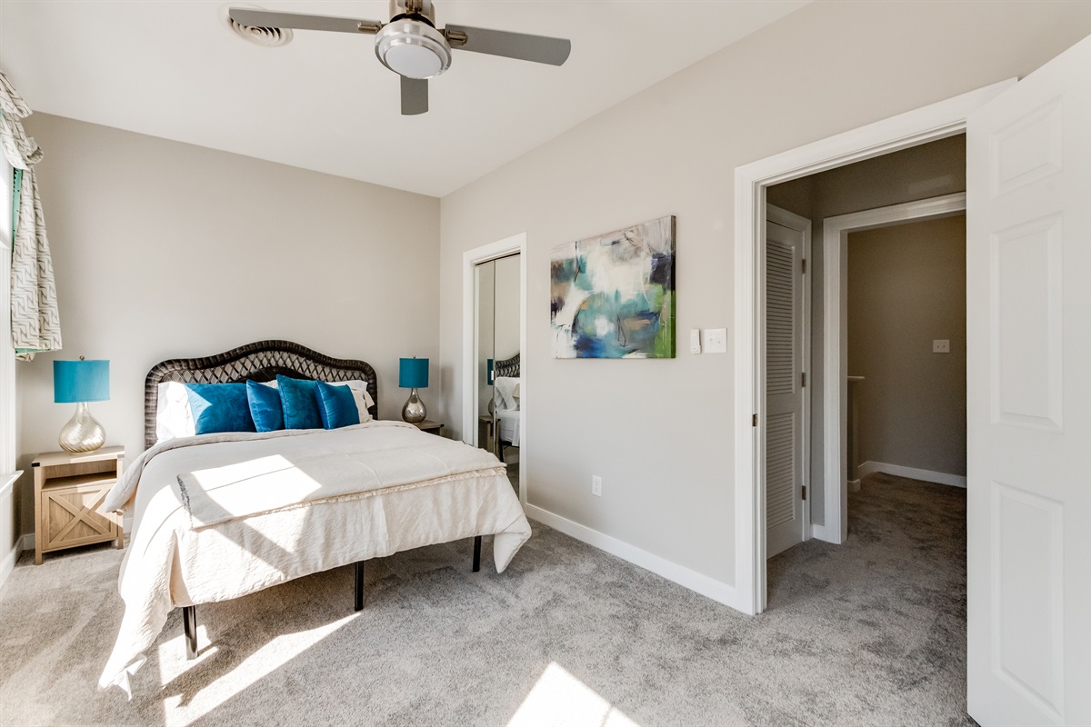 Queen Bedroom 2: Bright space with plush bedding and vibrant accents for a refreshing stay!