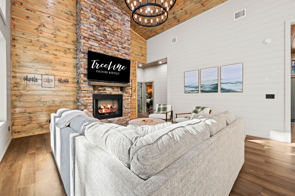 There’s no better place to share stories, laughter, and a glass of wine than by the fire in this cozy, open living area.