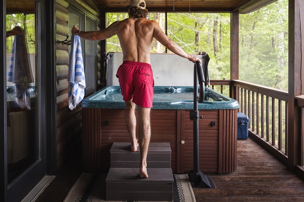 Climb into the private hot tub on the screened-in porch, just off the living room making it an easy transition from indoor comfort to mountain relaxation. 