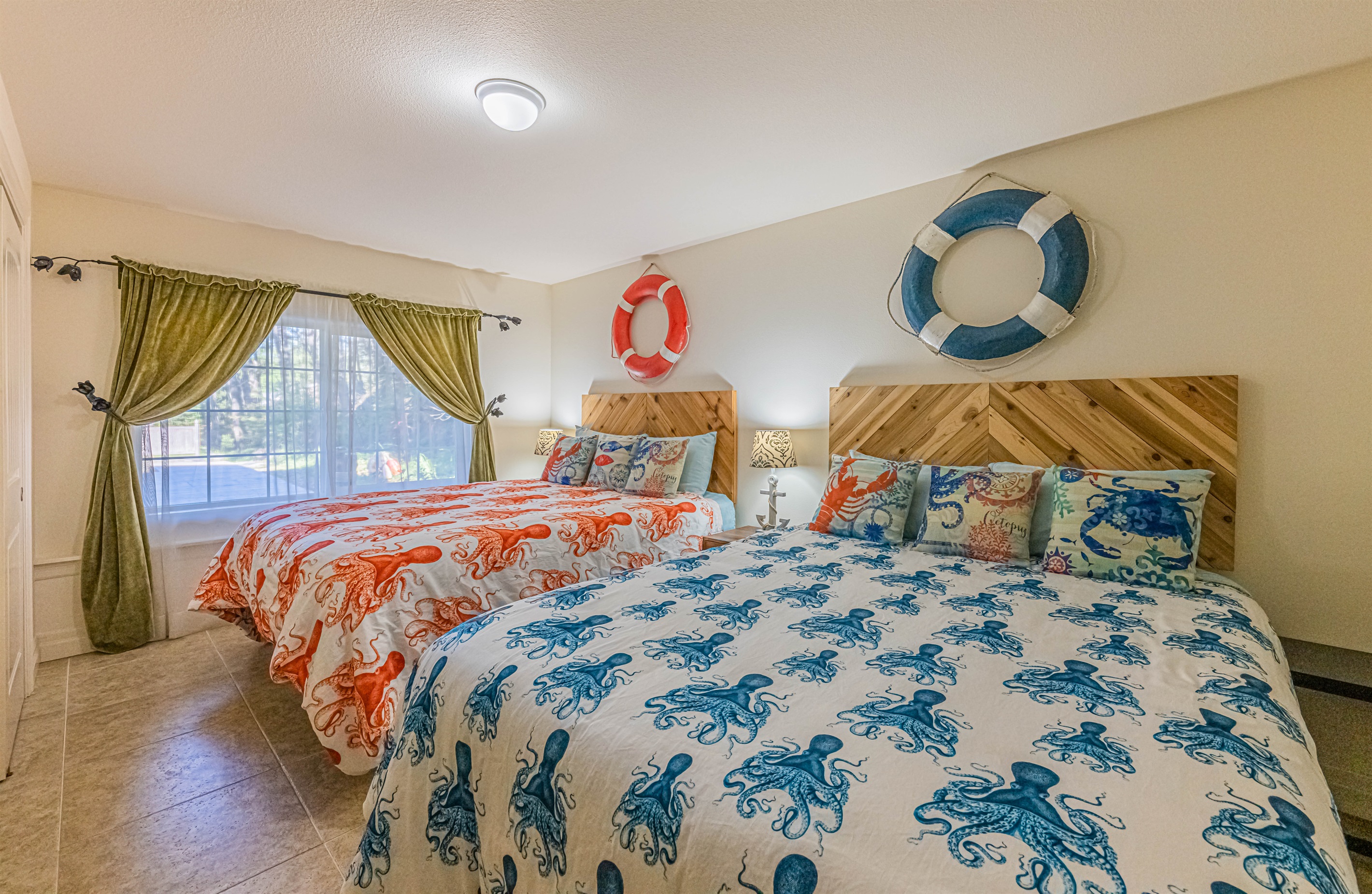 Basement bedroom is light and bright and complete with 2 comfy Queen size beds with memory foam mattress's and 55" TV.