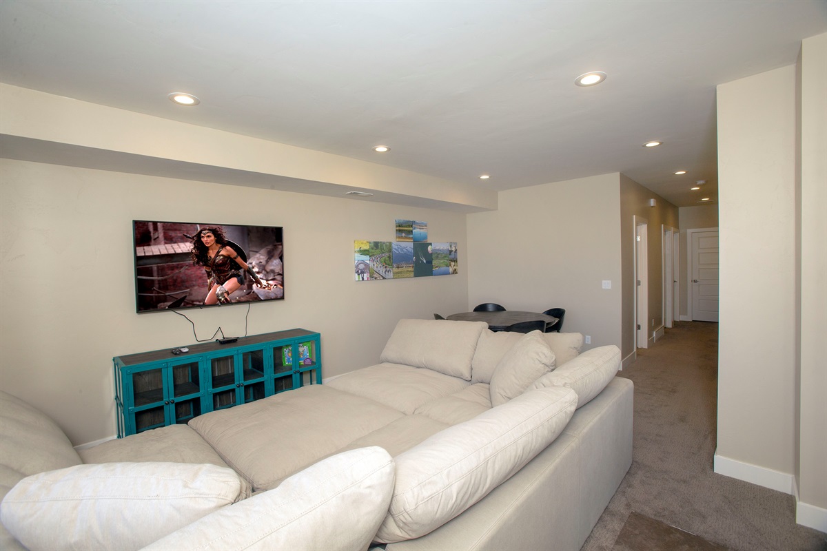 Entertainment space with large TV and comfortable seating for group gatherings.