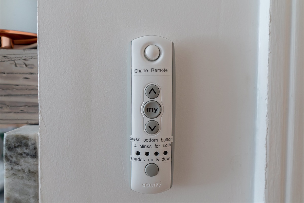 Remote on wall by kitchen to control the Zebra shades.