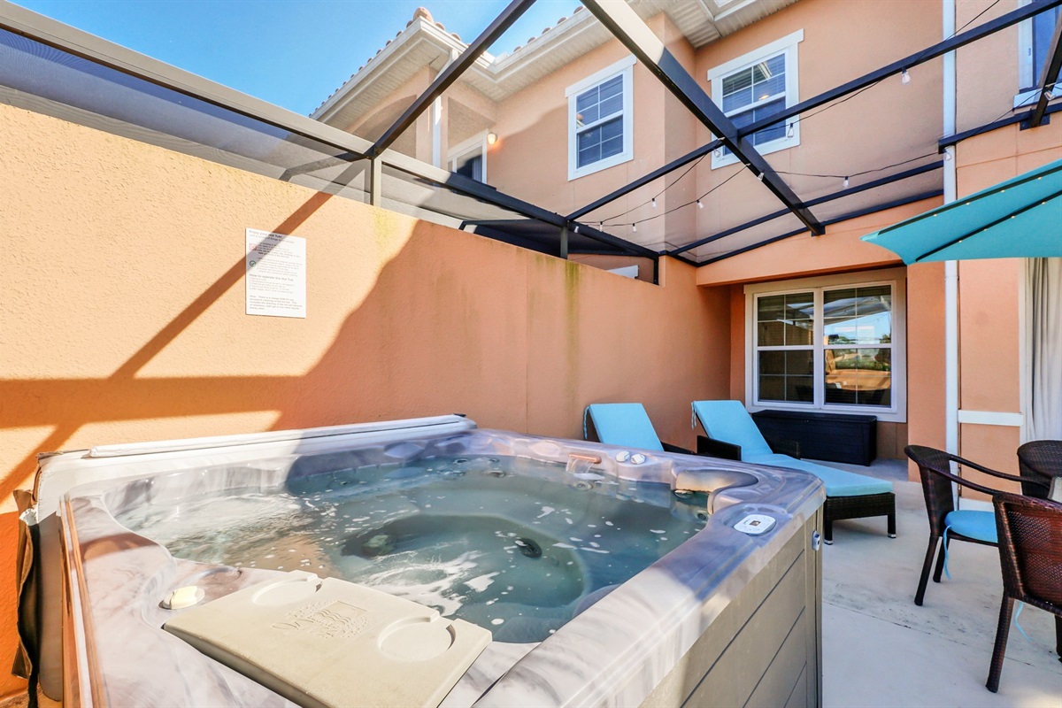 Private covered lanai with hot tub, dining area and lounge area