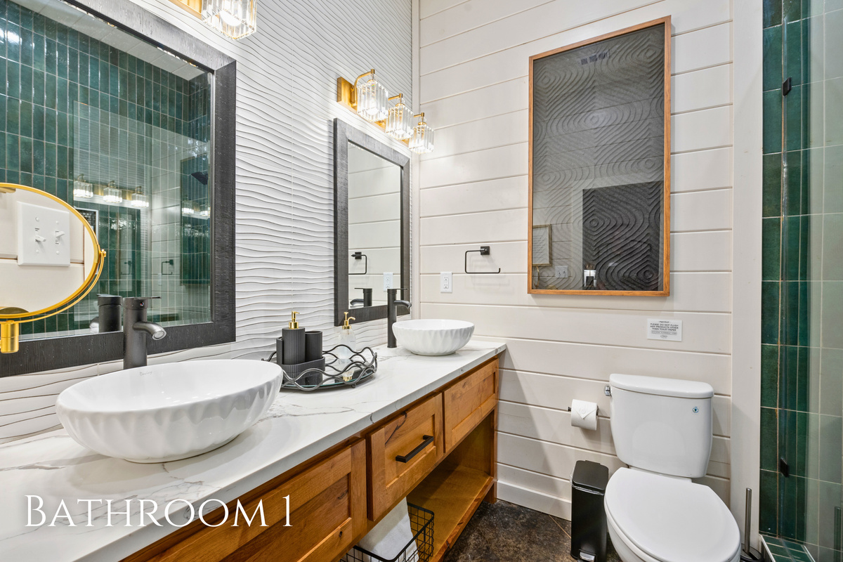 The ensuite bathroom features a beautiful vessel sink, stylish finishes, and plenty of space to get ready for the day ahead.