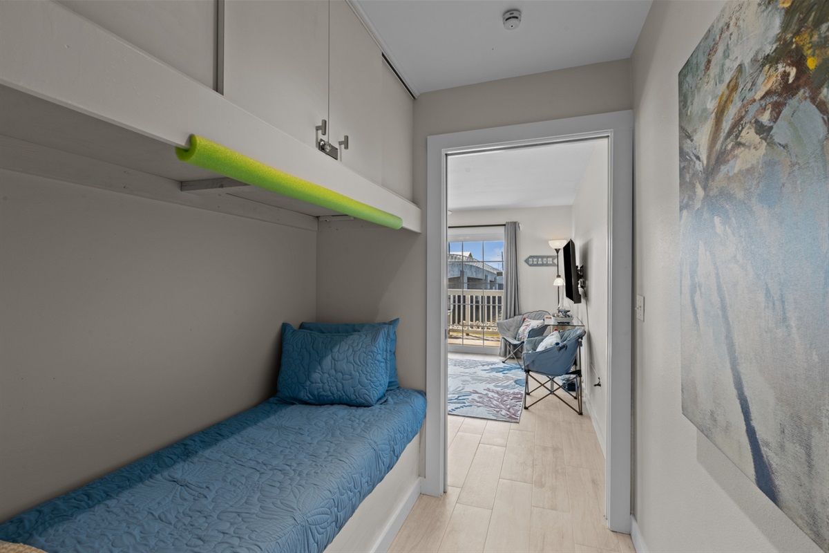 Twin bed sleeps one in hallway.