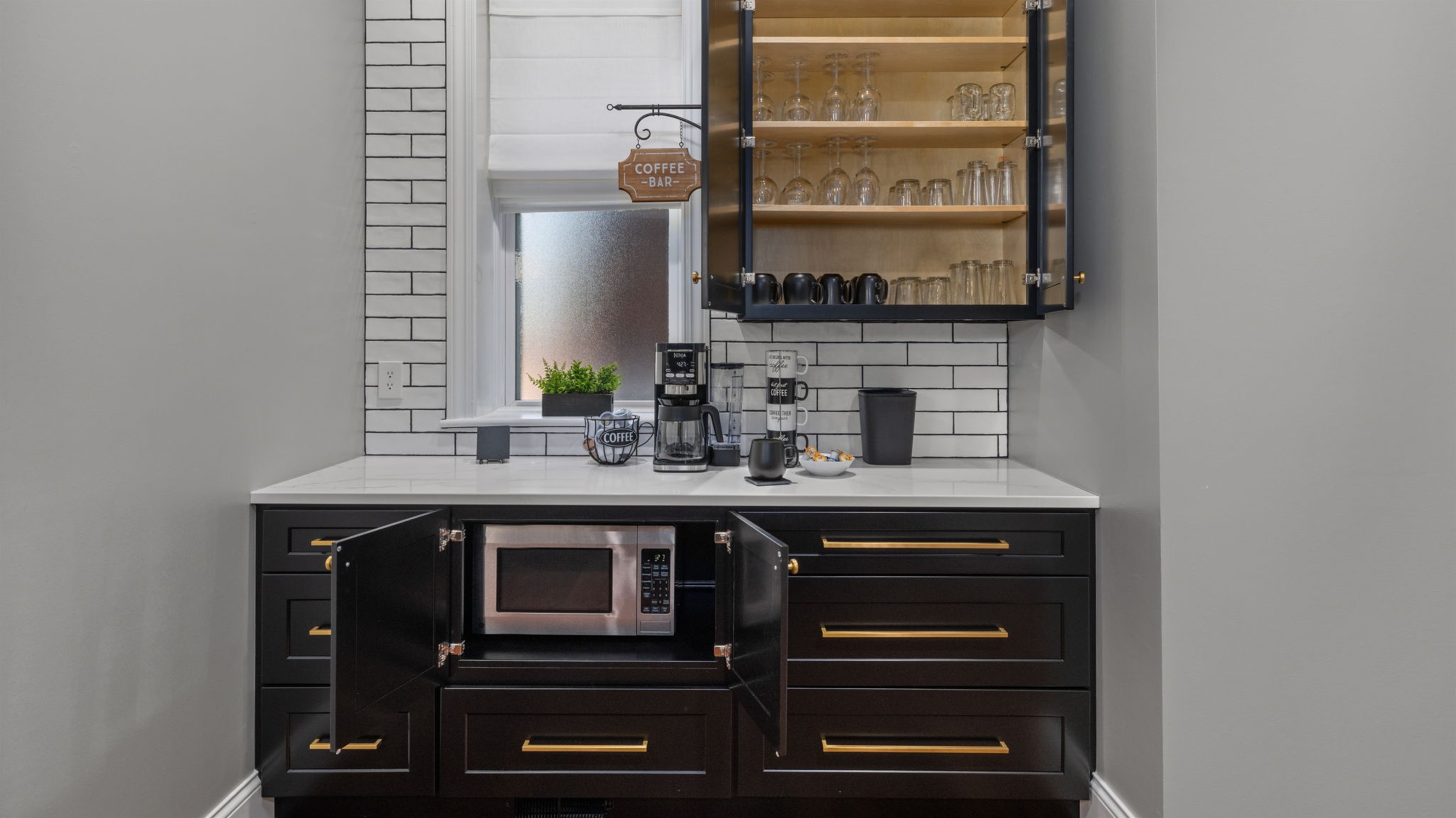 There are a variety of glasses and mugs for any particular need.  Feel free to look around.  Note the microwave is under the cabinet by the coffee bar!