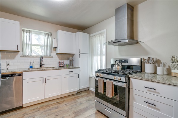 Large kitchen layout with oven, microwave, dishwasher, and deep sink