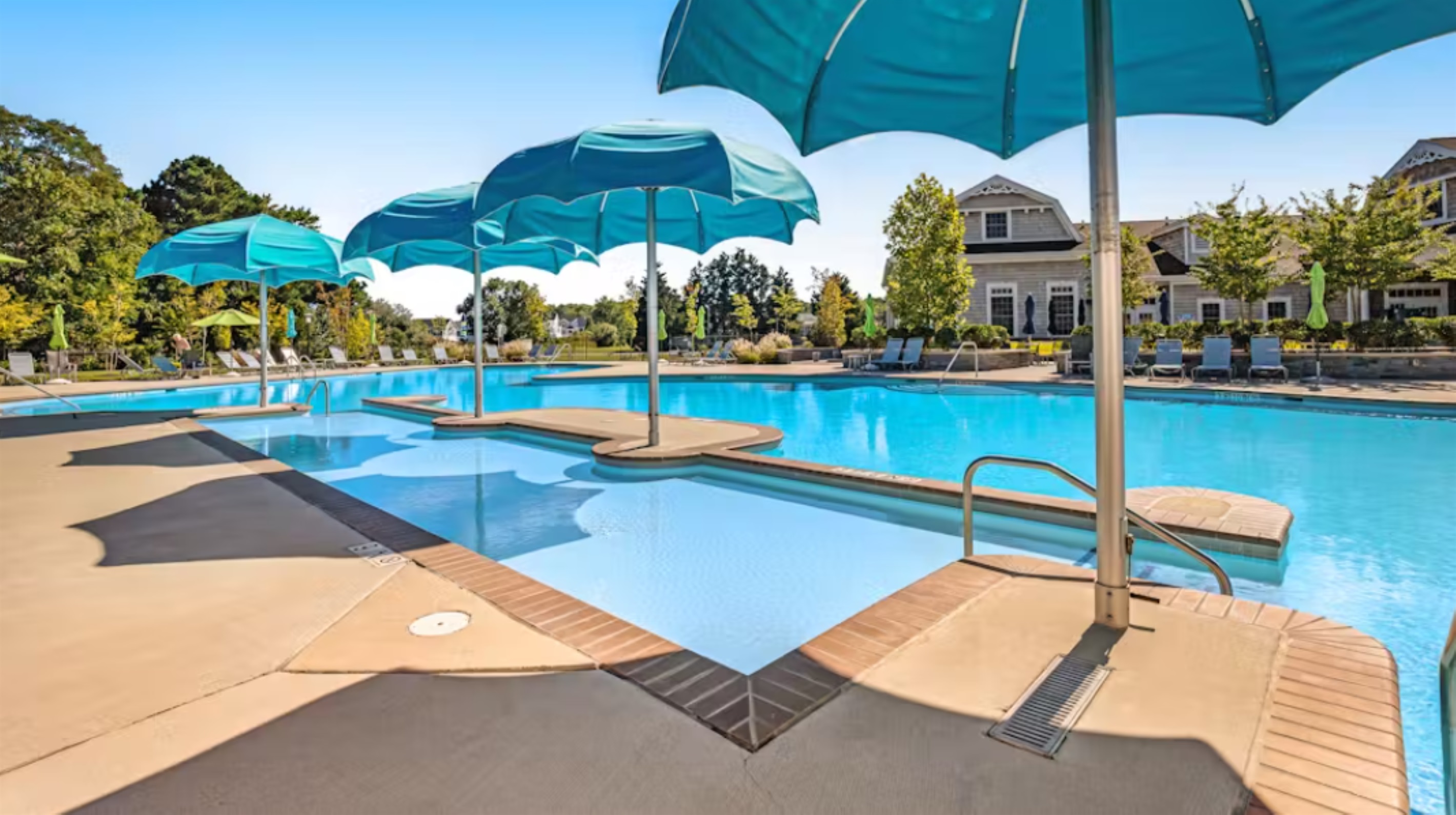 Adult-only hot tub surrounded by lounge seating and umbrellas—a serene spot for relaxation.