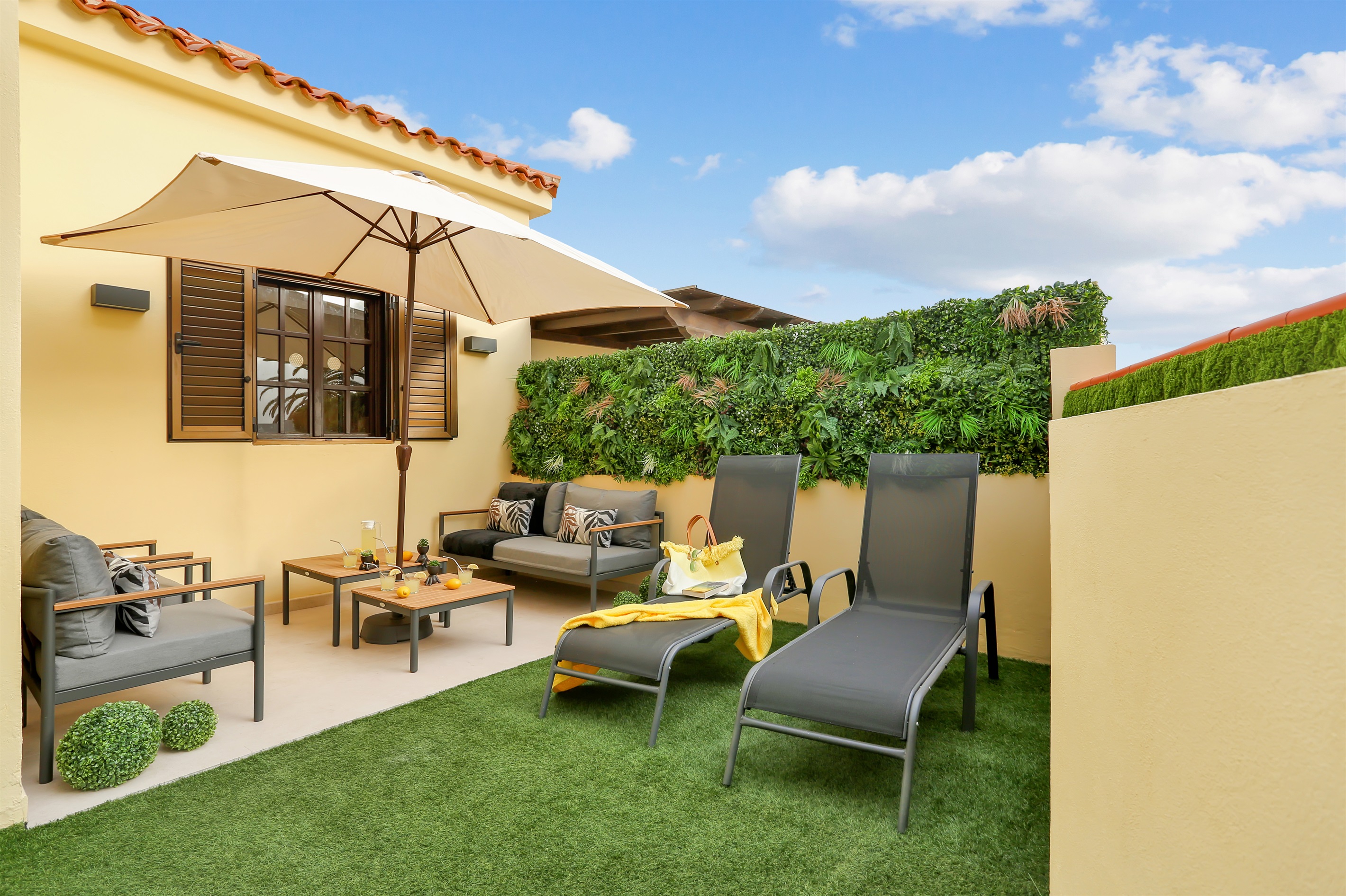 Sunny private garden with a chill-out area, sunbeds, and space to enjoy the outdoors throughout the day.