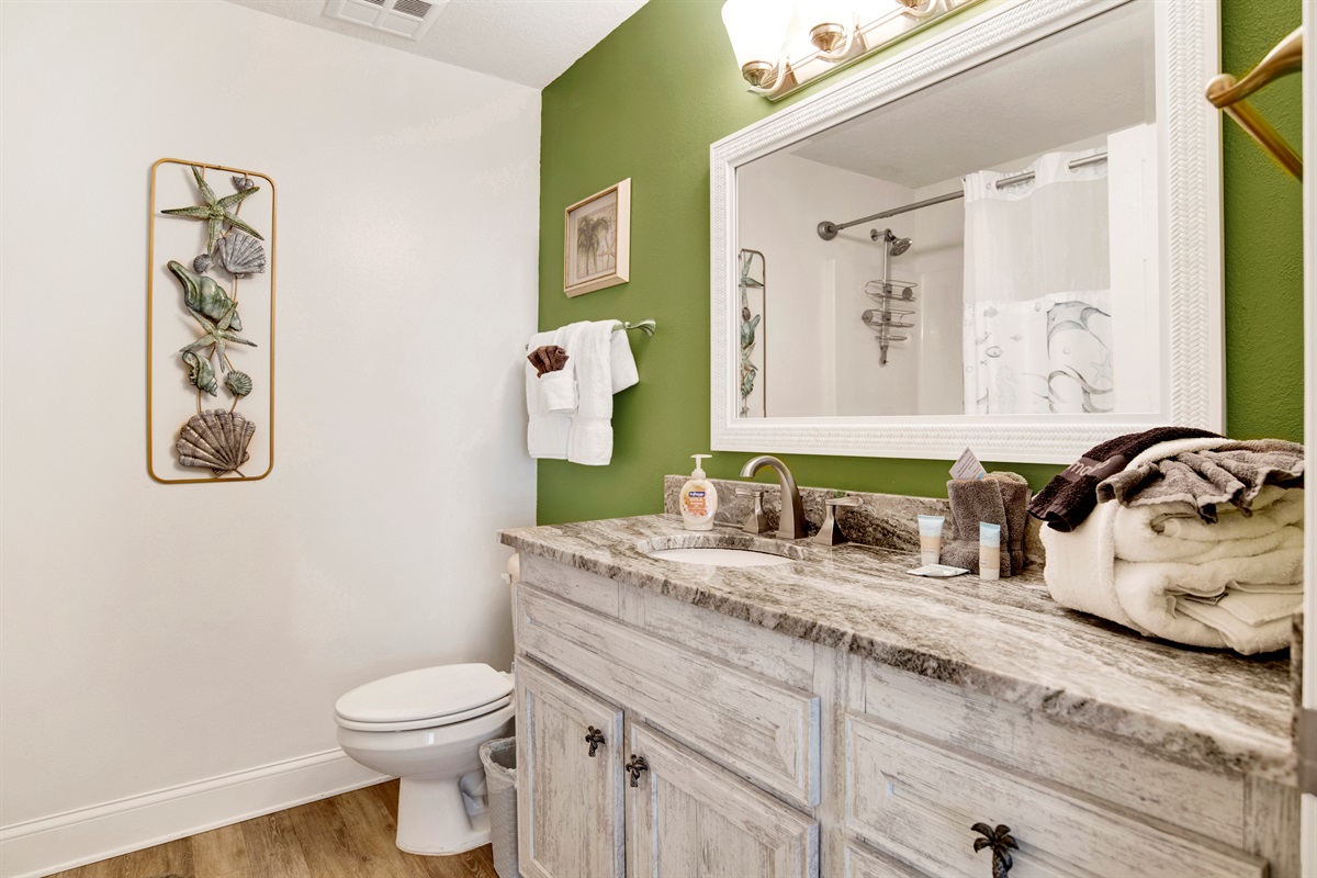 Master bathroom with tub/shower combo and extra long vanity with granite top.