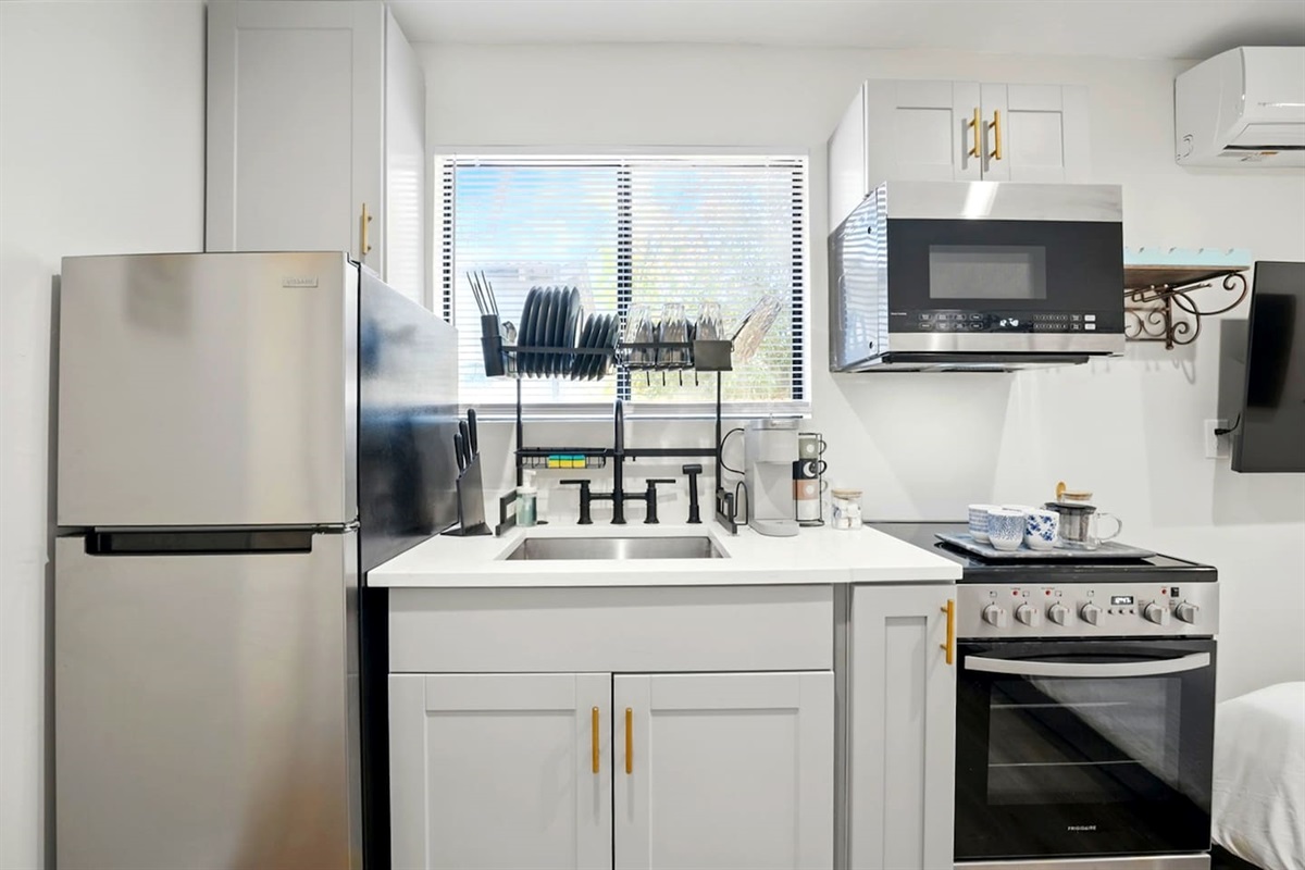 Sleek kitchen w/ fridge, cooktop & handy storage