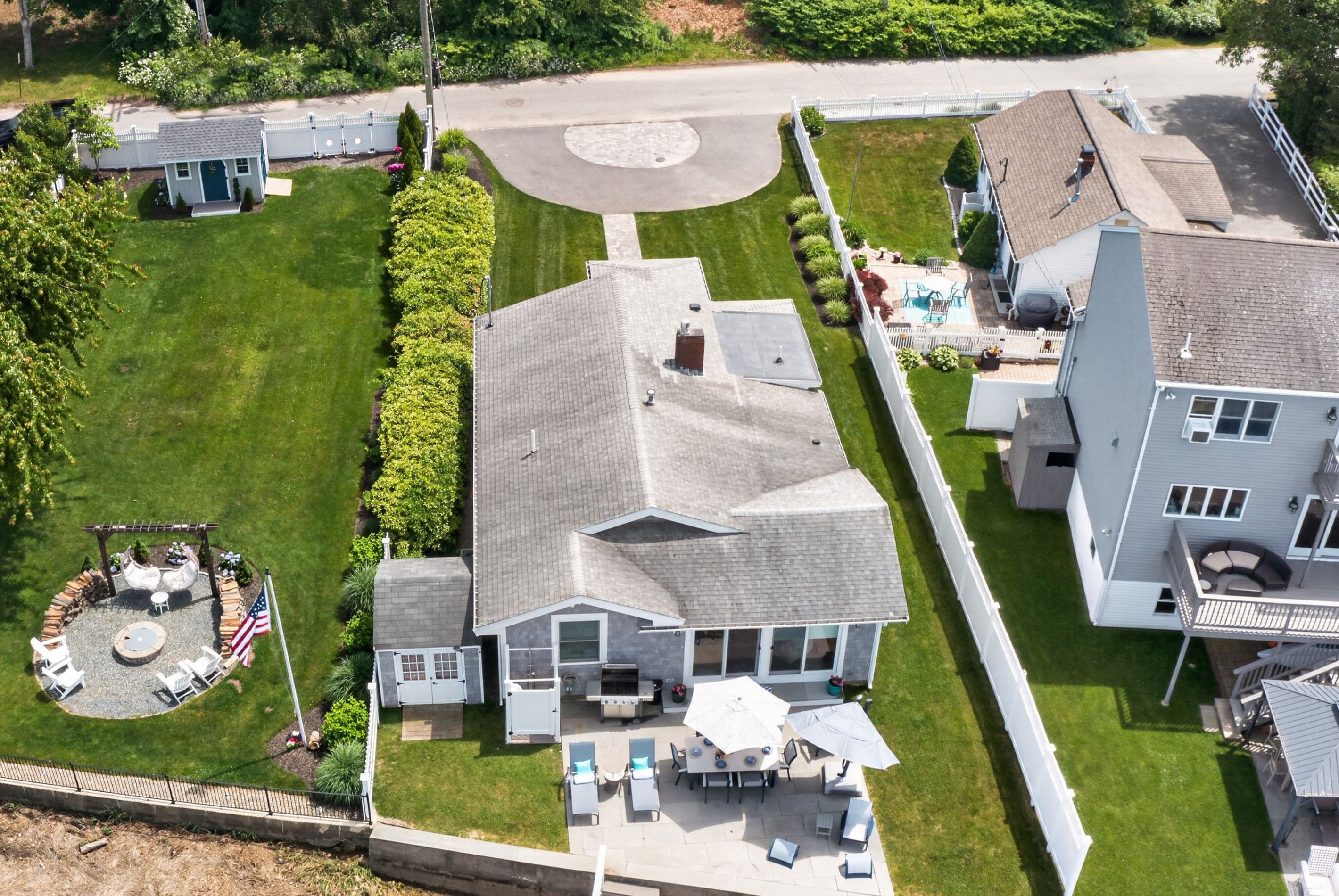 Overhead view showcasing the home's spacious outdoor living areas and waterfront setting.