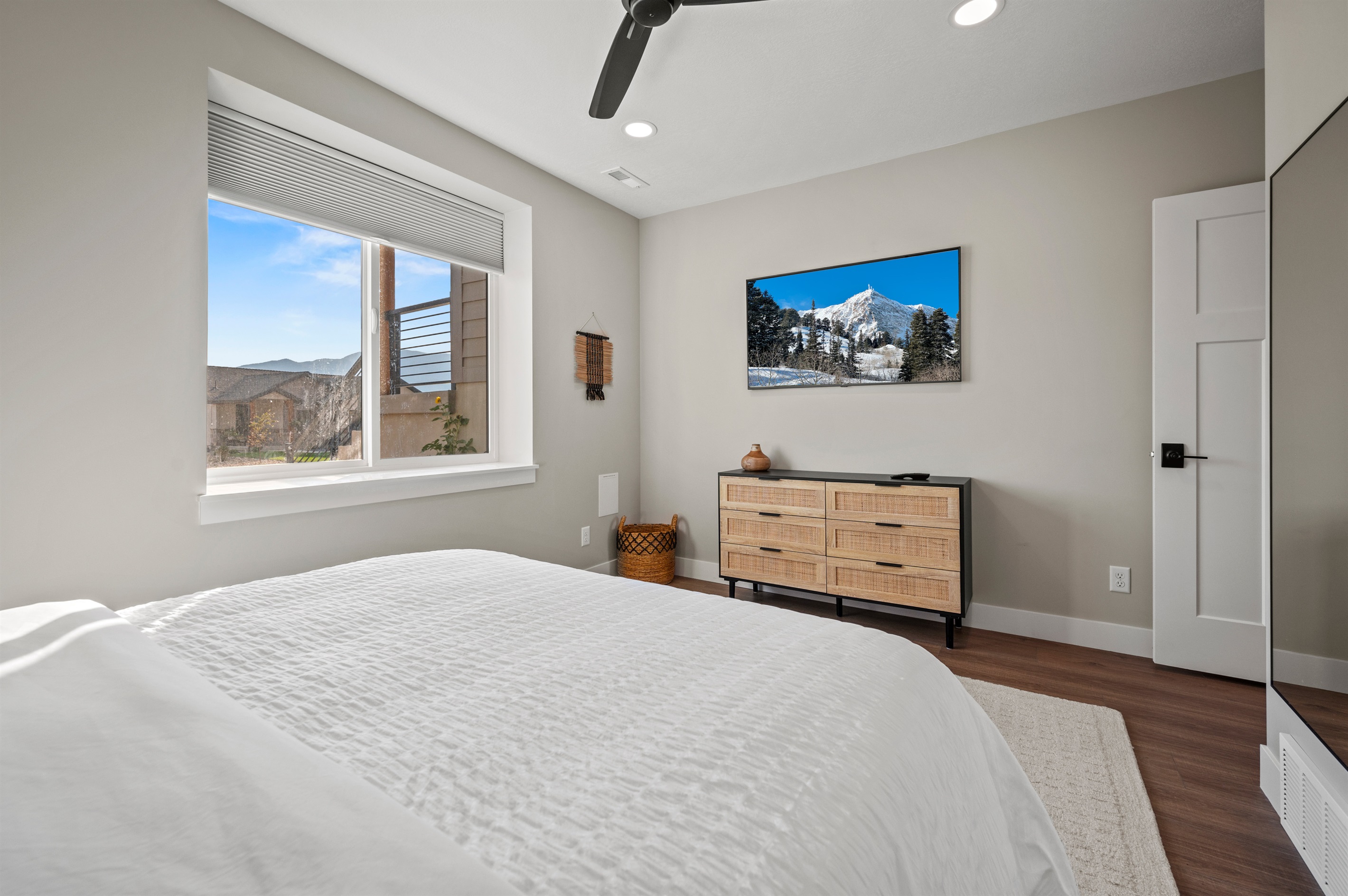 Enjoy mountain views right from your bed or stream your favorite movies, complemented by a beautiful dresser and ceiling fan.