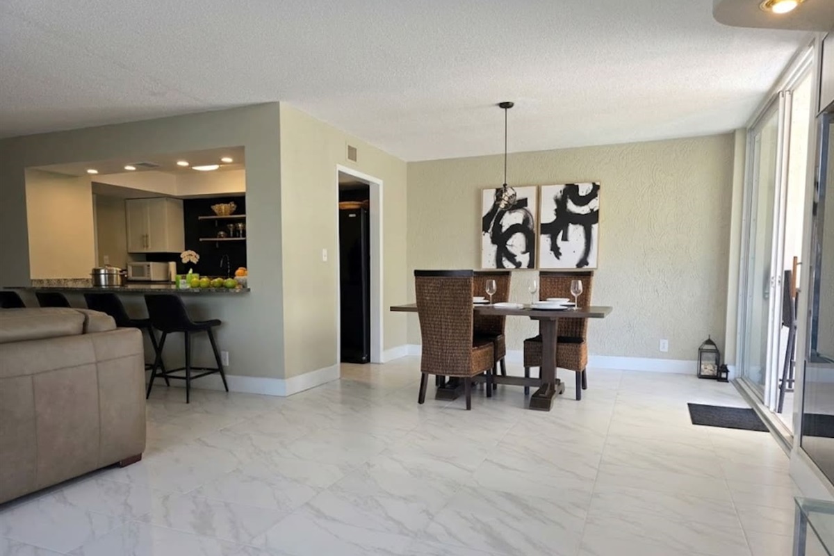 Dining room with seating for 4 at the table and 4 at the bar.