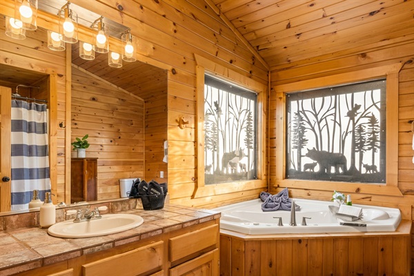 Primary ensuite with soaking jetted tub and separate stand up shower.