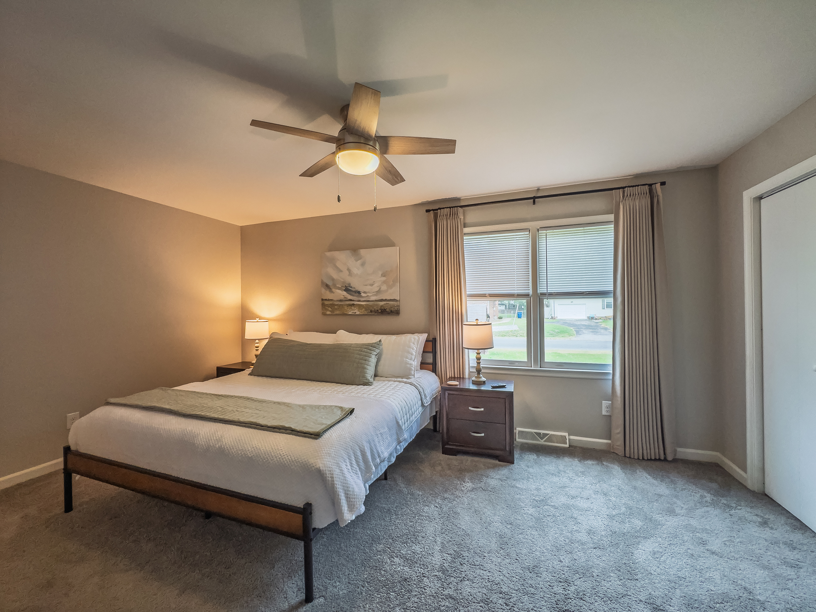 Primary Bedroom, King bed, 55" Smart TV, ceiling fan, two led light nightstands with multiple charging ports, two multi light function lamps, blackout curtains, dresser and closet, private full bathroom.
