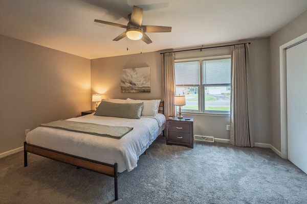 Primary Bedroom, King bed, 55" Smart TV, ceiling fan, two led light nightstands with multiple charging ports, two multi light function lamps, blackout curtains, dresser and closet, private full bathroom.