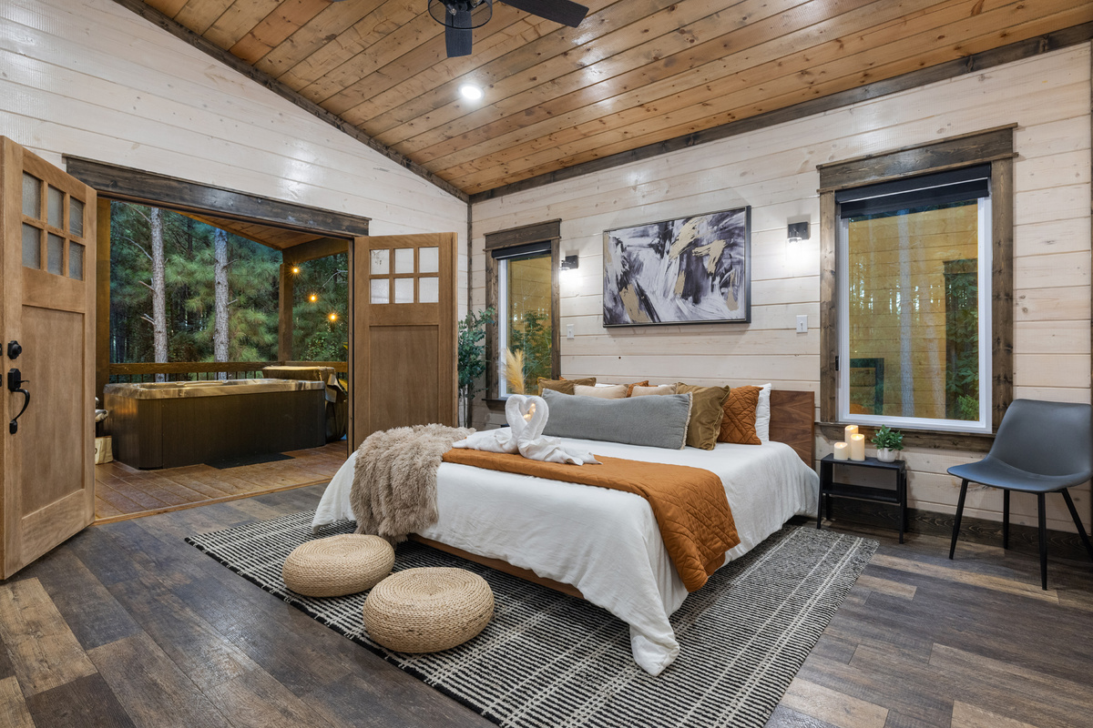 Your king suite opens straight to the covered patio and hot tub, making late night soaks and slow mornings in the pines just steps from bed.