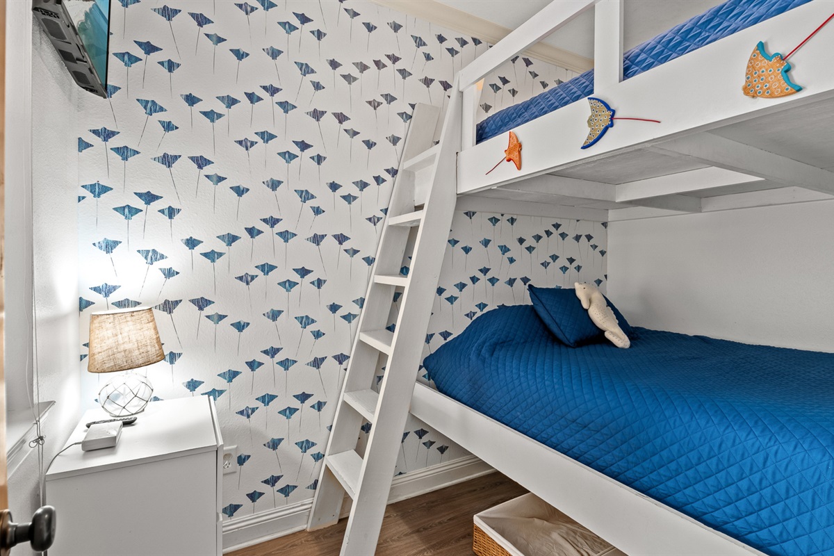 The kids' room they'll tell all their friends about. Queen-over-queen bunks with whimsical fish wallpaper built for cousins sharing a room.