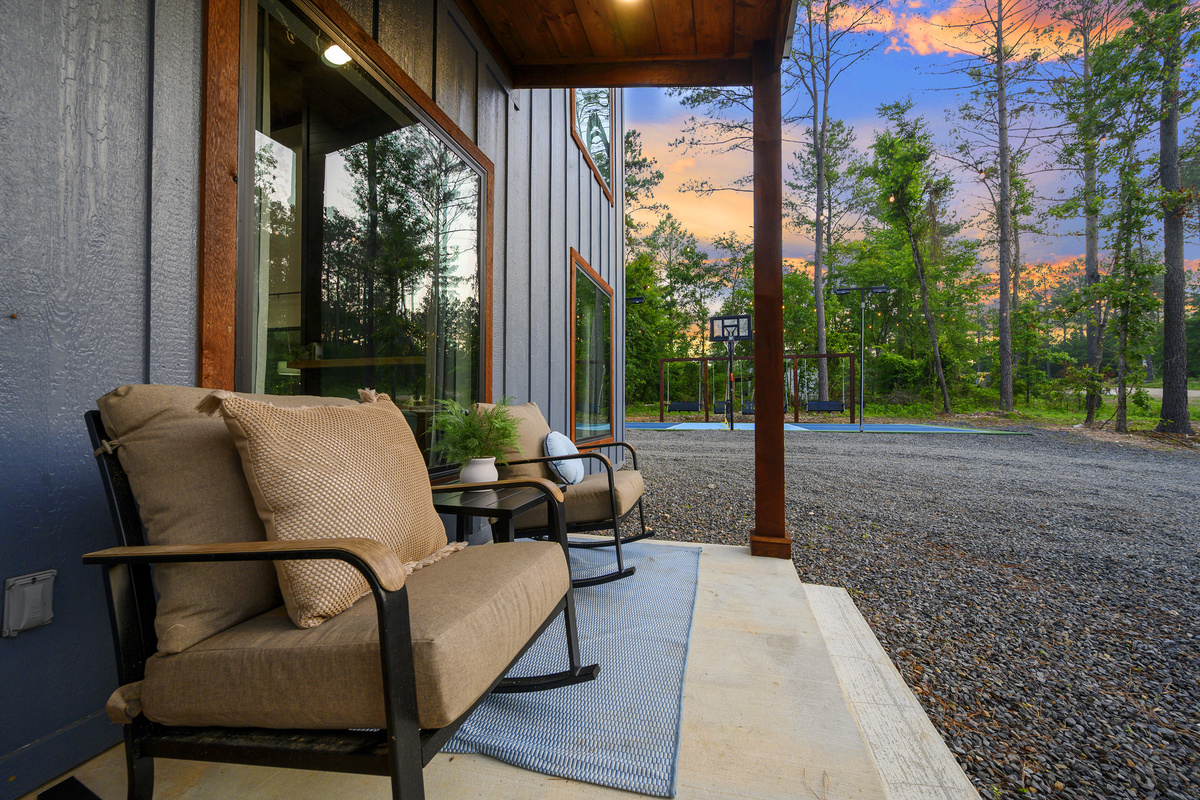 A quiet front porch moment with sunset views and the basketball court just beyond. The perfect balance of slow evenings and a little friendly competition.
