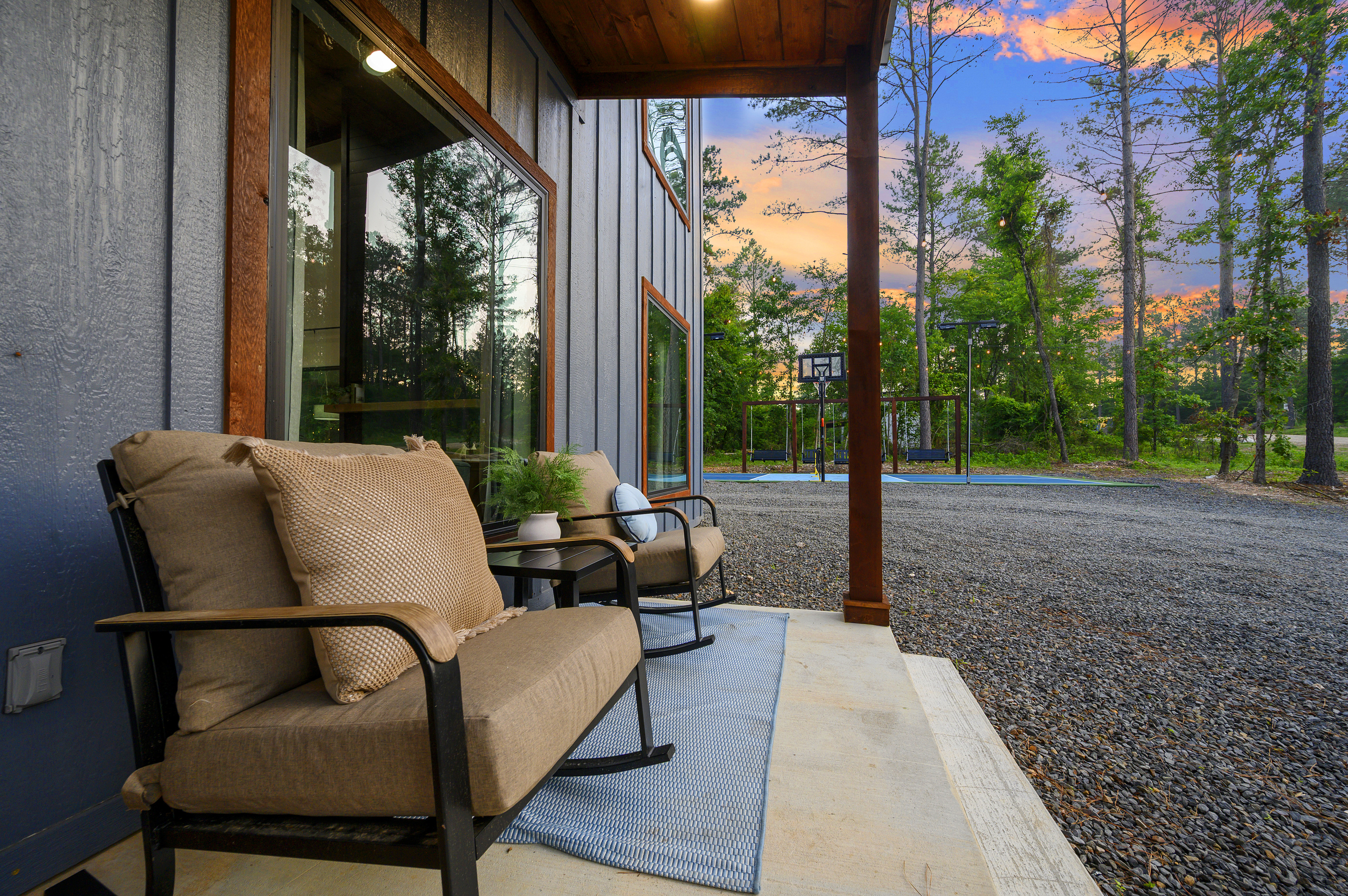 A quiet front porch moment with sunset views and the basketball court just beyond. The perfect balance of slow evenings and a little friendly competition.
