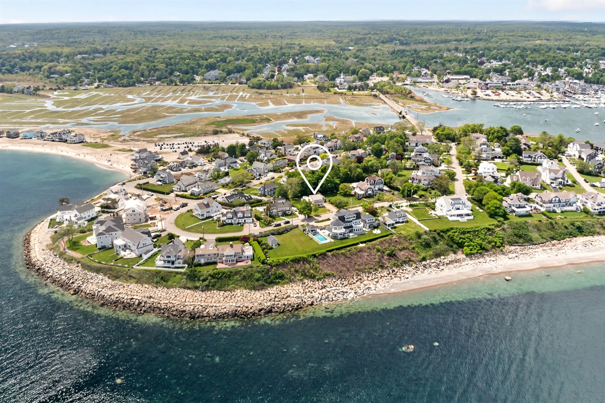 An aerial view of the house and its surrounding coastal landscape.