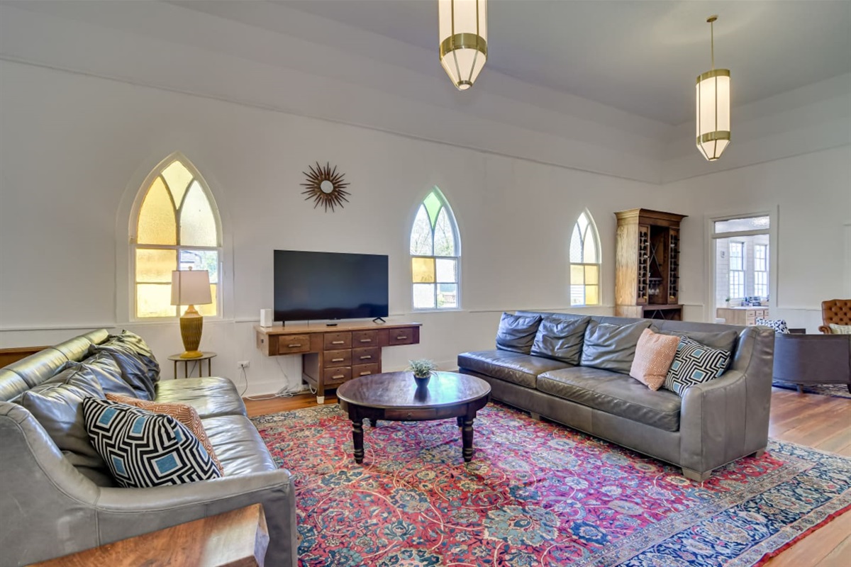 Vintage lounge with patterned rug and original wood trim.