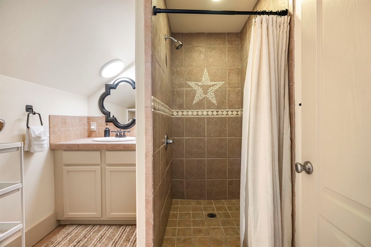 A full bathroom offers a single sink, shower, and toilet, providing everything needed for a self-contained stay.