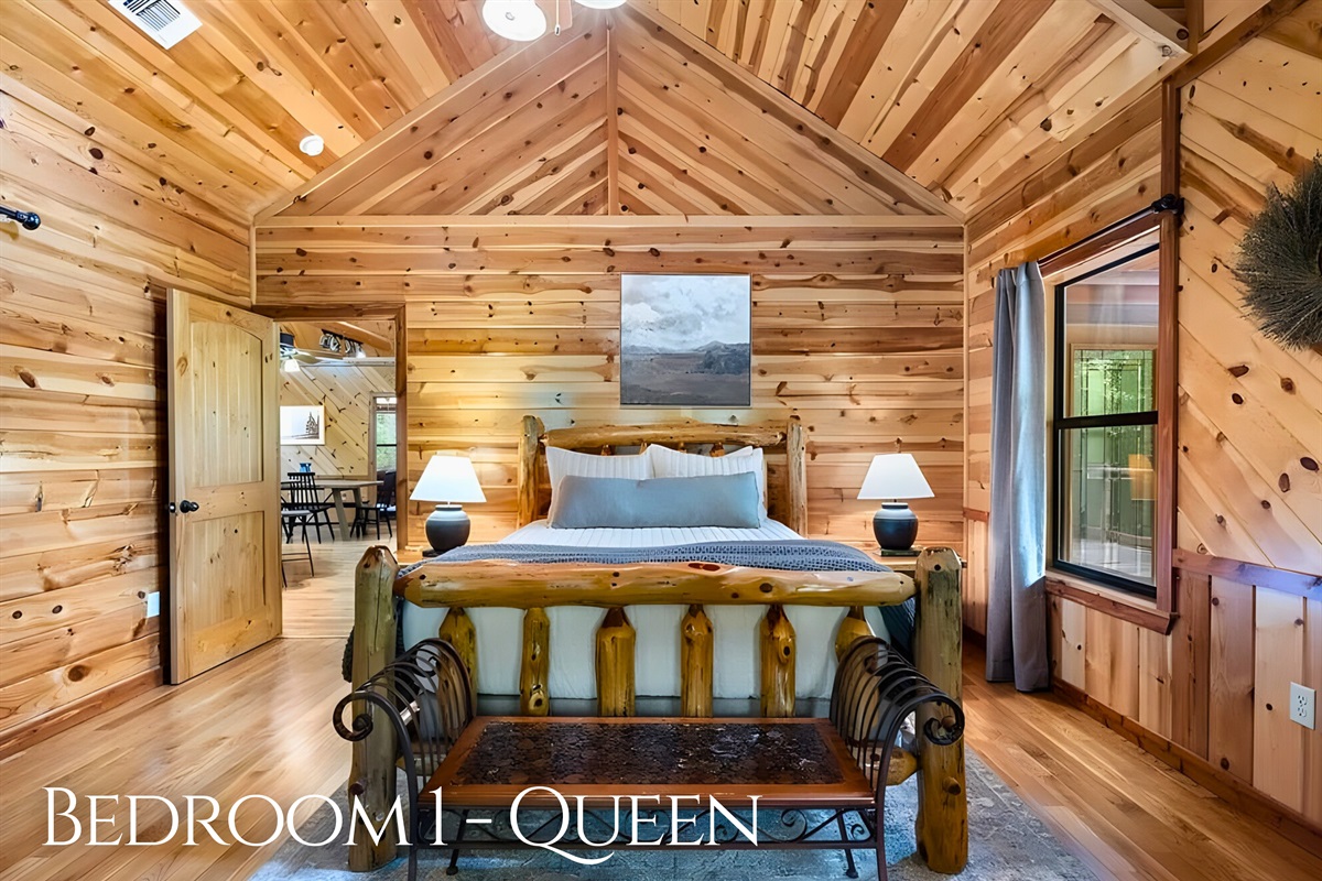 Rest easy in the primary queen bedroom with cozy cabin details.