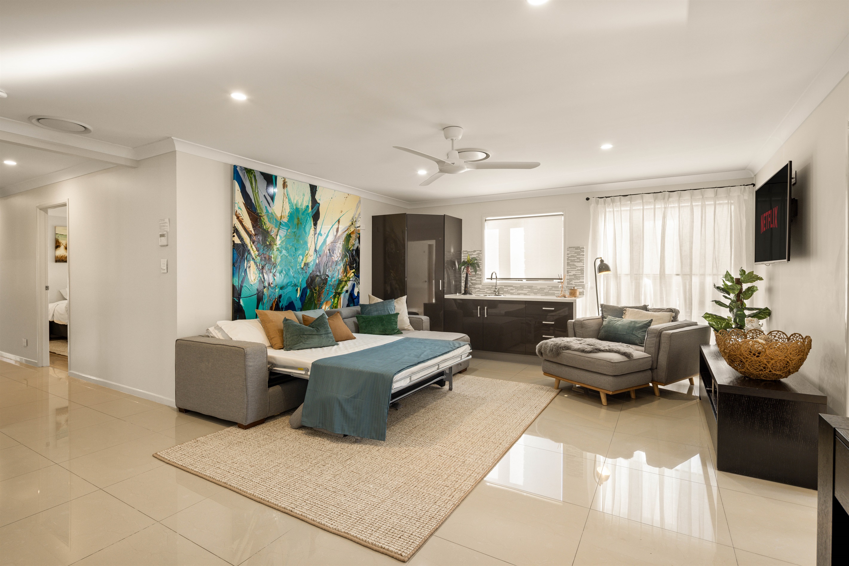 Flexible upper-level living zone with double bed setup for additional guests