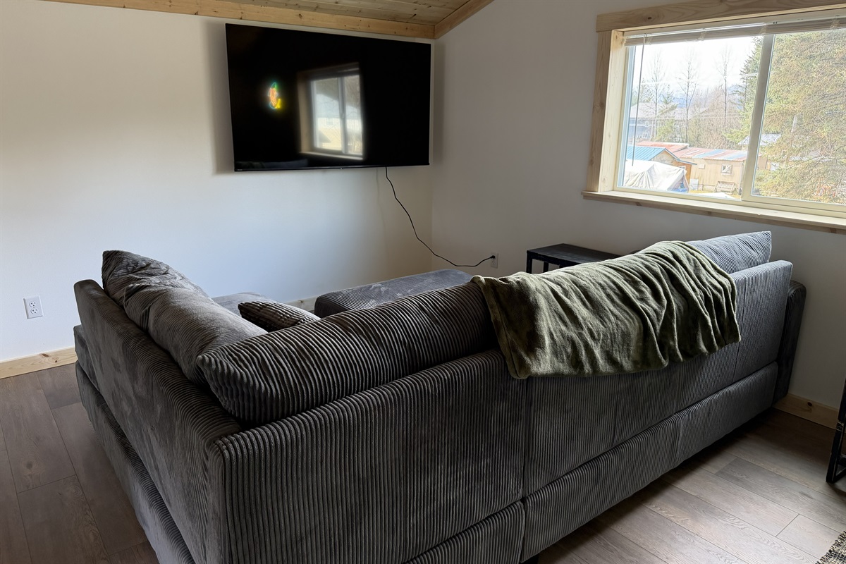 Loft living area - sectional sofa and big screen TV
