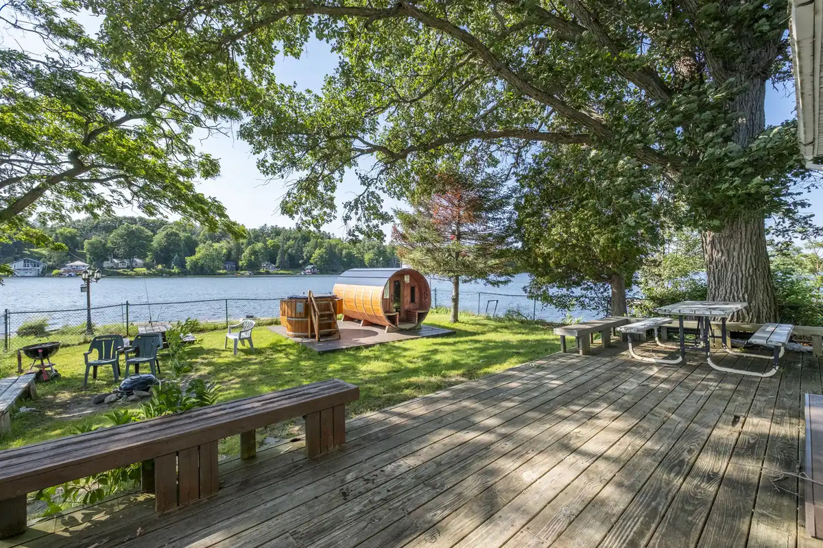 Outdoor deck area with trees and waterfront views