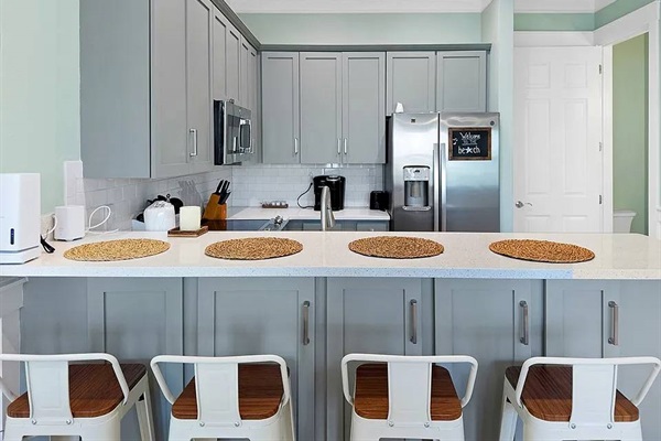 Island with room for seating or serving dinner.