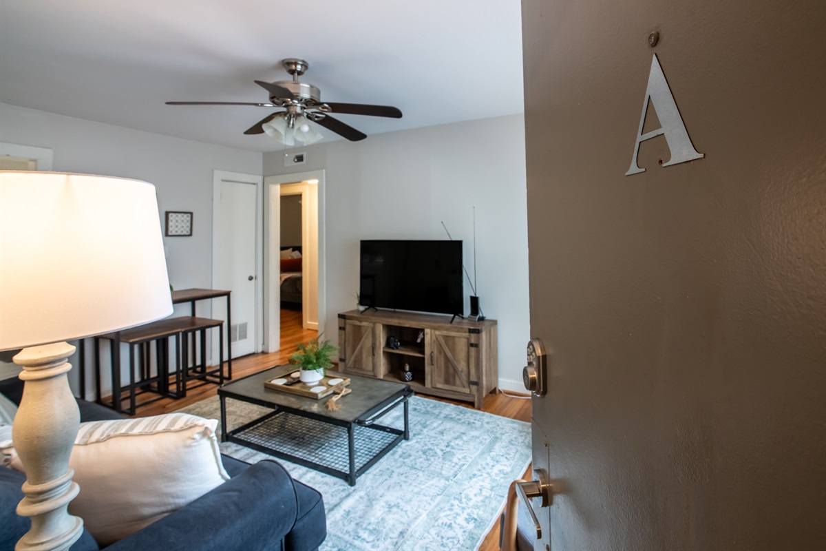 Open-concept living space with ceiling fan and thoughtful decor, offering comfort and style in one inviting setting.