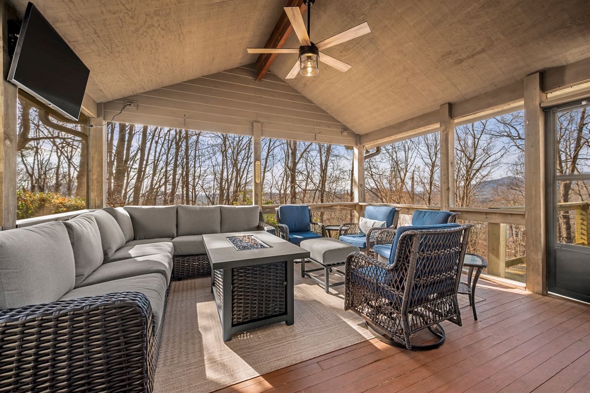 Open screened in porch with seating, tv, and more