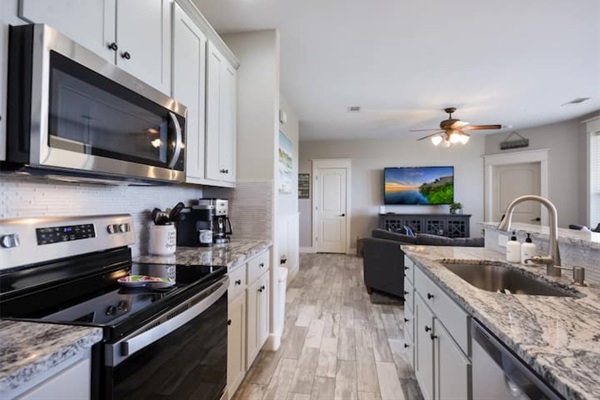 Fully equipped kitchen with stainless steel appliances, granite countertops, and an island for easy meals during your stay