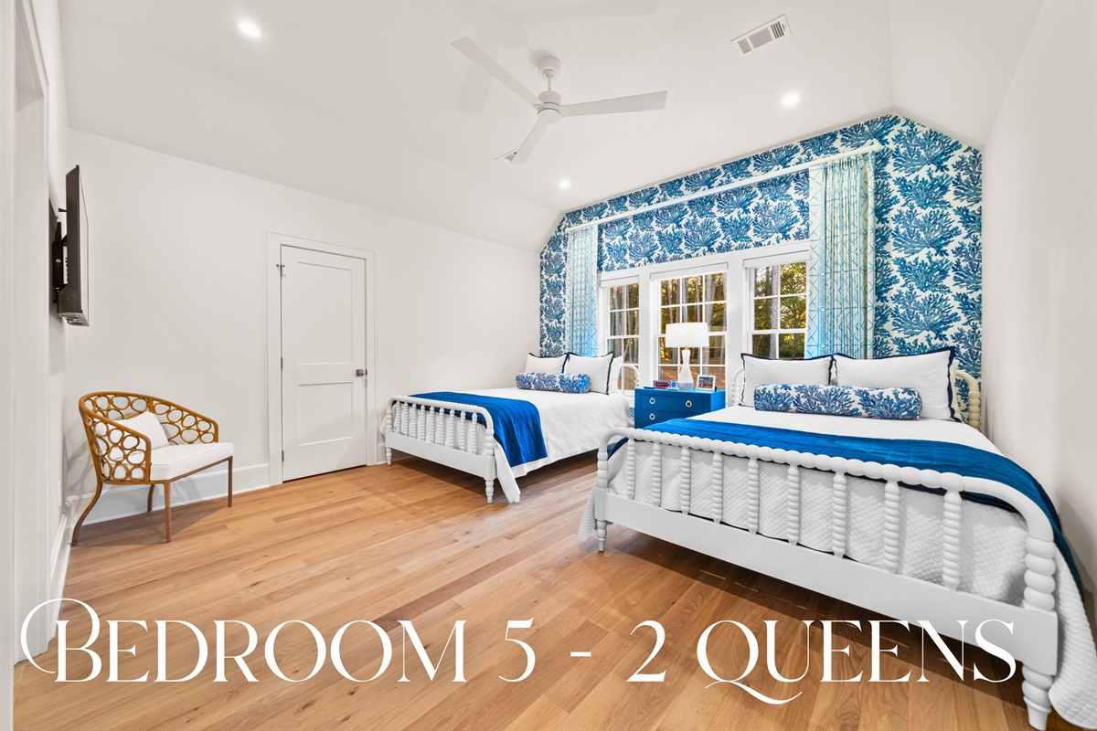 Guest room with nautical-inspired decor and queen beds.